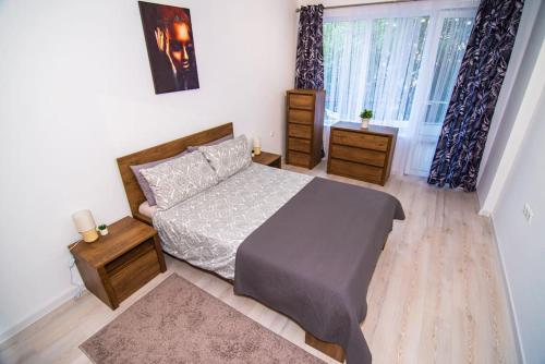 a bedroom with a bed and a large window at Benny's flat in Stara Zagora