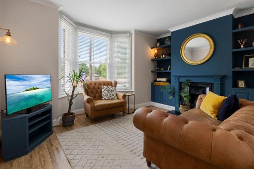 a living room with a couch and a tv at Quayside Haven in Exeter