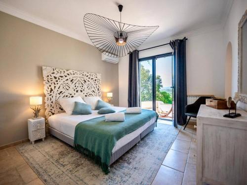 a bedroom with a large bed and a large window at Villa moderne 6 CH pour 12 avec piscine privée, clim et parking aux Issambres - FR-1-768-24 in Les Issambres