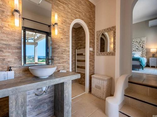 a bathroom with a sink and a bedroom at Villa moderne 6 CH pour 12 avec piscine privée, clim et parking aux Issambres - FR-1-768-24 in Les Issambres