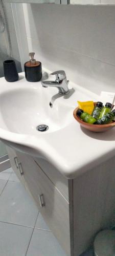a bathroom sink with a bowl of vegetables on it at DOBA House in Baveno