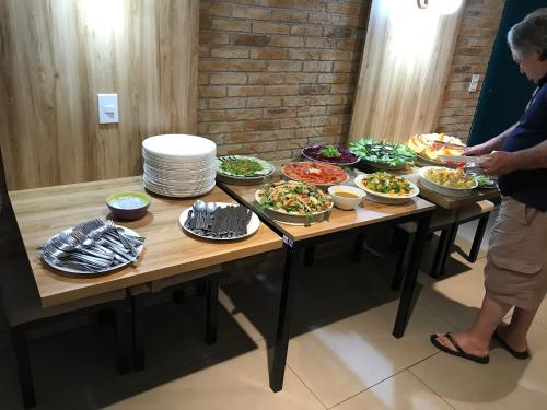 a table with many plates of food on it at Landscape Beira Mar - Lindo, Luxo, Frente mar in Fortaleza