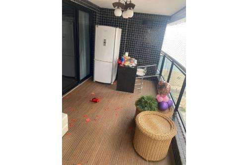 a balcony with a refrigerator and a doll on the floor at Landscape Beira Mar - Lindo, Luxo, Frente mar in Fortaleza