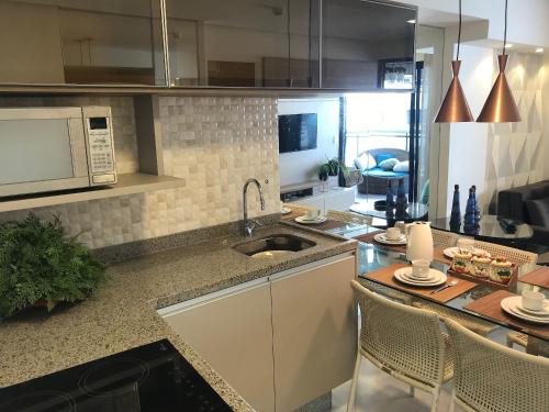 a kitchen with a sink and a counter top at Landscape Beira Mar - Lindo, Luxo, Frente mar in Fortaleza