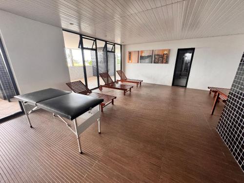 a room with benches and tables in a building at Landscape Beira Mar - Lindo, Luxo, Frente mar in Fortaleza