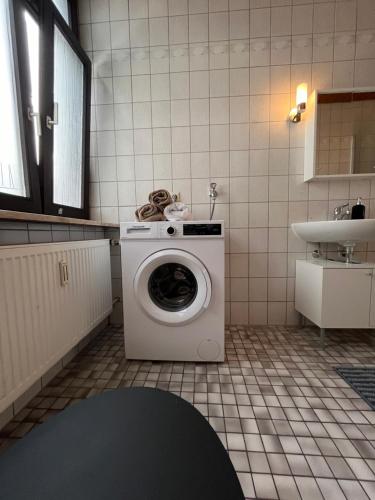 a washing machine in a bathroom with a sink at Charmantes Apartment in Karlsruhe
