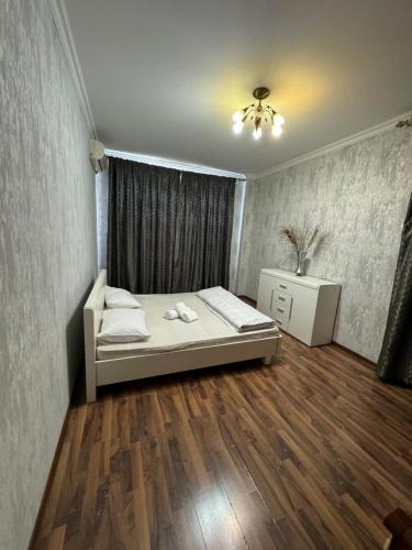 a small bedroom with a bed and a window at Трехкомнатная просторная квартира 137 кв центре возле ТЦ Infinity Mall in Atyraū