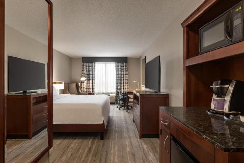 a hotel room with a bed and a television at Hilton Garden Inn Fort Myers Airport/FGCU in Fort Myers