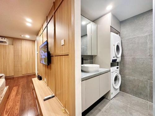 a small bathroom with a washer and dryer in it at HOD Apartment Tan Dinh in Ho Chi Minh City