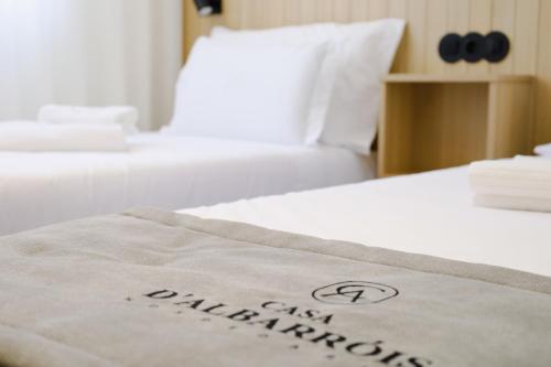 a close up of a bed with a towel on it at Casa d'Albarróis in Alenquer