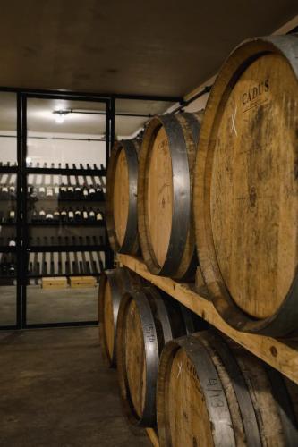 a bunch of wine barrels stacked in a cellar at Casa d'Albarróis in Alenquer