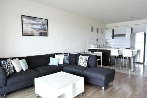 a living room with a couch and a table at Eden Dream Apartments in Limassol