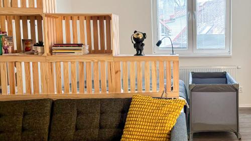 a living room with a couch and a book shelf at Remote Work Friendly Zahradní apartmán u jezera in Staré Splavy