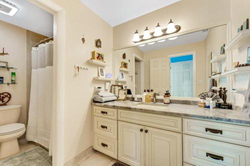 a bathroom with a sink and a toilet at Walk to North Beach in Clearwater Beach