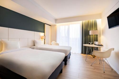 Postel nebo postele na pokoji v ubytování Hotel Louise