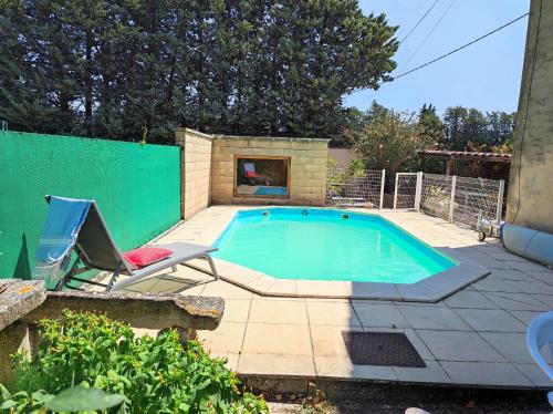- une piscine avec une chaise et une chaise dans l'établissement Chambre de 1 personne dans Mas de Lubéron, à Robion