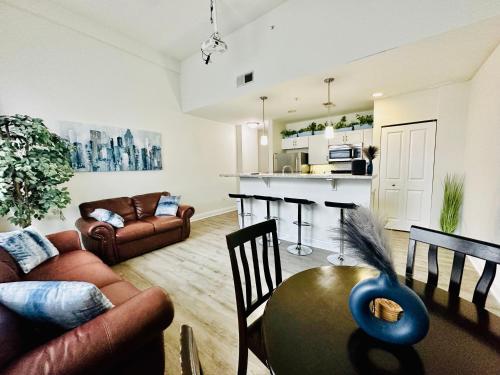 a living room with a couch and a table at Two Bedroom Game Day Suite with 100 Projector TV in Indianapolis