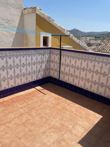 a balcony of a house with a tile wall at Casa Juana Cehegín in Cehegín
