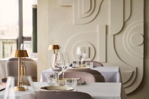 a row of tables with wine glasses on them at Legacy Gastro Suites in Heraklio Town