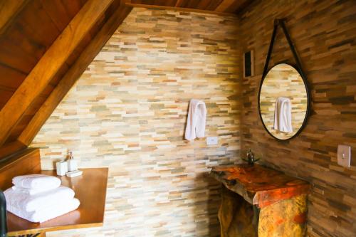 a bathroom with a pile of towels on a wall at Villa Iturri in Campos do Jordão