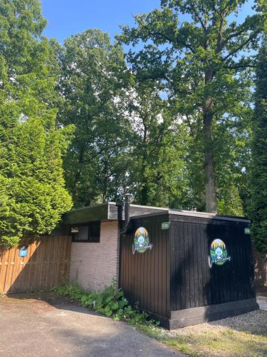 a black fence with two posters on it at Vakantiehuis Lanaken in Lanaken