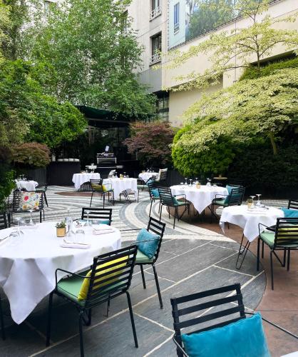 a group of tables and chairs with white tables at Novotel Paris Les Halles in Paris