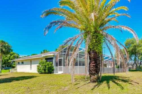 a palm tree in front of a house at Spring Hill Home Private Pool, 9 Mi to Beach! in Spring Hill
