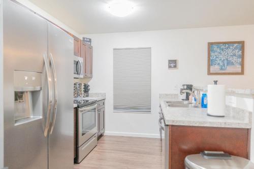 a kitchen with a stainless steel refrigerator at Lower Northern Tanada Suite 2.0 (B) in North Pole