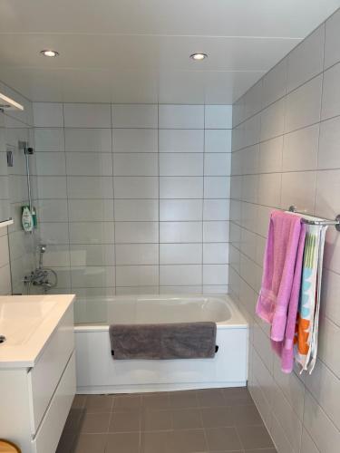 a bathroom with a tub and a sink at Penthouse apartment - Lillestrøm in Lillestrøm