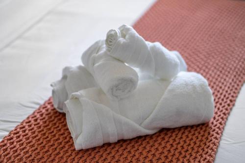 a pile of white towels sitting on a table at Large House Near Calgary Airport with Central AC, Double Car Garage Parking, Upgrade Stay, Netflix, Sleeps 8 in Calgary