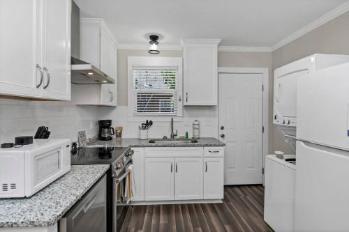 a kitchen with white cabinets and a white refrigerator at Hollywood Hideaway - 1BR 1BA in Columbia