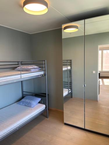 a room with two bunk beds and a mirror at Penthouse apartment - Lillestrøm in Lillestrøm