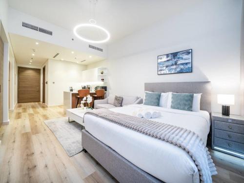a bedroom with a large bed and a living room at Cosy Modern Waterfront Studio in Maritime City in Dubai