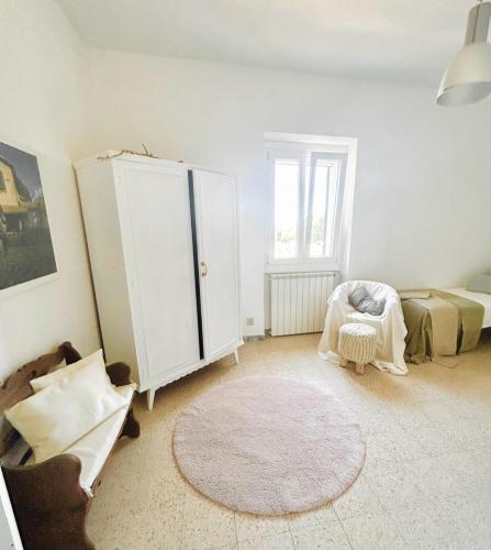 a living room with a white cabinet and a rug at Casa a Tuscania - Borgo Stays in Tuscania