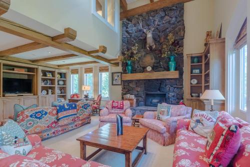 a living room with couches and a stone fireplace at Lodge Apartment II Condo 886 in Sun Valley
