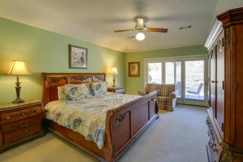 Un dormitorio con una cama y un ventilador de techo. en Lake Balboa Access Home with Dock and Yard, en Hot Springs Village