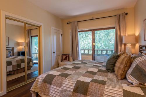 a bedroom with a bed and a large window at Wildflower Condo 655 in Sun Valley