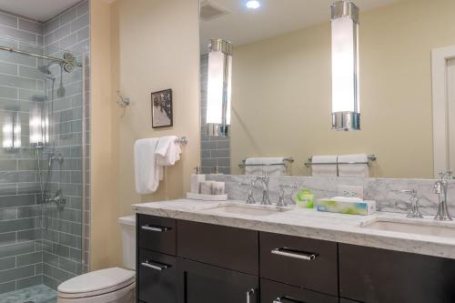 a bathroom with a sink and a toilet and a mirror at Wildflower Condo 655 in Sun Valley