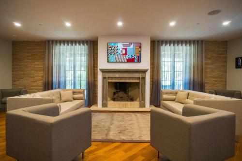 a living room with two couches and a fireplace at Le Cappuccinelle Suites&SPA in Perugia
