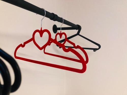 a pair of hearts on a clothes line at Arona Picasso's House Modern Art in Arona