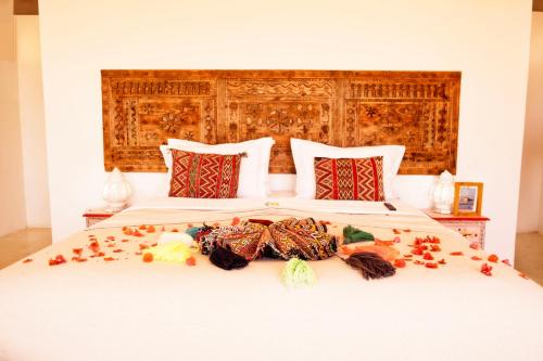 a bedroom with a bed with flowers on it at PK25 Dakhla in Dakhla