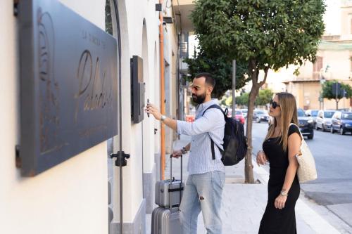 a man and a woman standing outside of a store at La Dimora dei Paladini in Bagheria