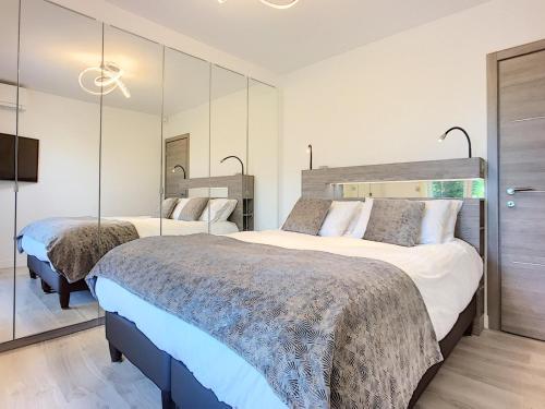 - 2 lits dans une chambre d'hôtel avec miroirs dans l'établissement Cannes Maria Luxe et confort à 10 min à pied de la Croisette et du Palais, à Cannes
