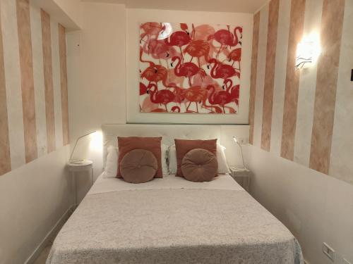 a bedroom with a bed with a painting on the wall at Giardino Giusti House & Court in Verona