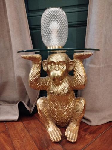 a gold monkey holding a glass table with a microphone at Nancy Vieille Ville Stanislas in Nancy