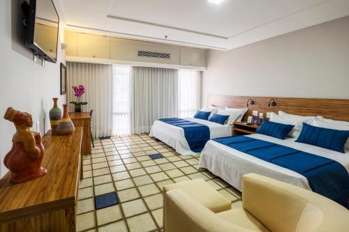 Postel nebo postele na pokoji v ubytování Fiesta Bahia Hotel