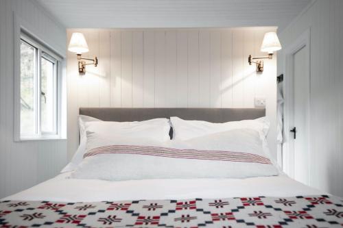 a bedroom with a bed with a red and white quilt at Timber Cottage in Acharacle
