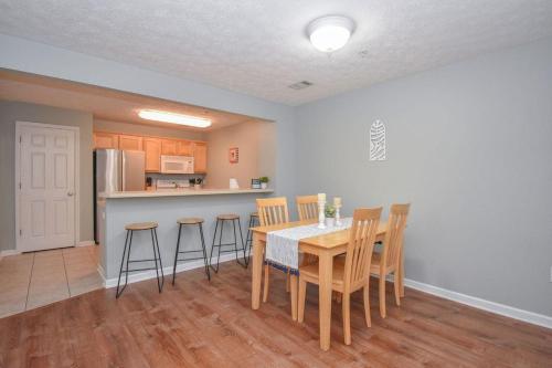 a kitchen and dining room with a table and chairs at Eagle's Edge In Auburn in Auburn