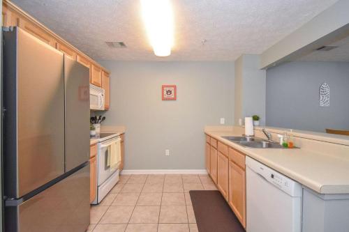 a kitchen with a stainless steel refrigerator and a sink at Eagle's Edge In Auburn in Auburn