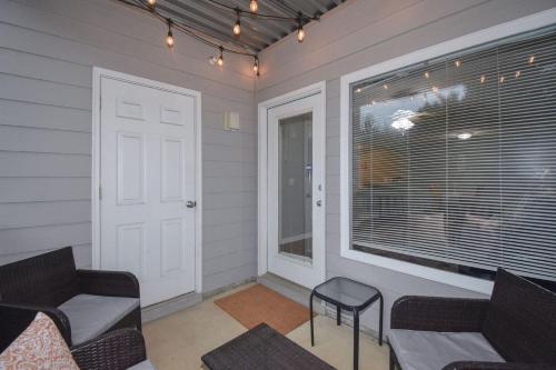 a room with two couches and a window and a door at Eagle's Edge In Auburn in Auburn